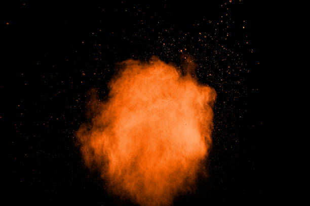 istock orange dust particles explosion on black background. Color powder dust splash. 1059263364