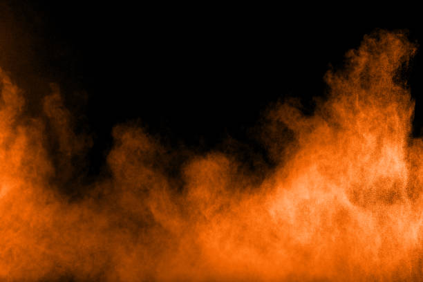 istock orange dust particles explosion on black background. Color powder dust splash. 1059263456