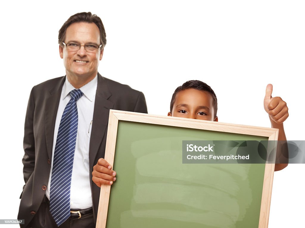 Hispanic Boy Holding Chalk Board with Male Teacher Behind Hispanic Boy Holding Chalk Board with Male Teacher Behind Isolated on a White Background. 40-49 Years Stock Photo