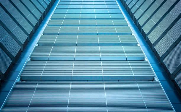 istock underside panoramic and perspective view to steel blue glass high rise building skyscrapers, business concept of successful industrial architecture 1059268578