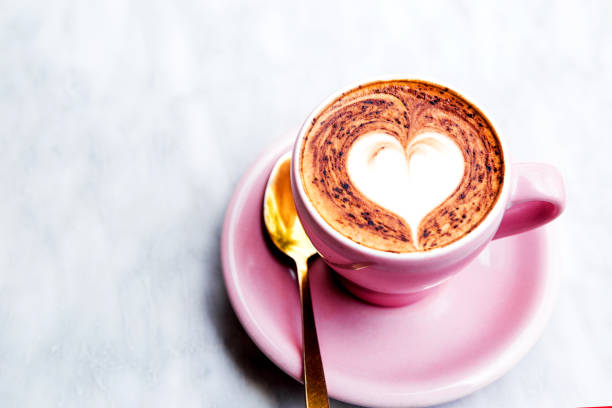 istock Cappuccino cup with heart latte art on marble table background 1059268814