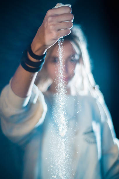 istock Young woman dropping white powder from her hand 1059270802
