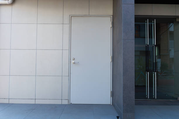 istock sidewalk by street wall & door 1059273018