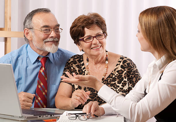 istock Three people in a meeting with a laptop on the desk 105927361