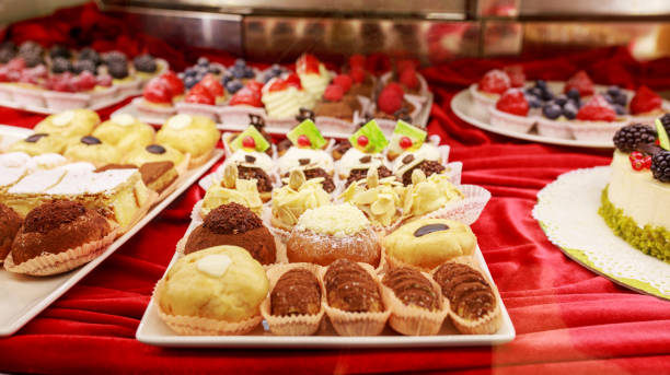 istock Different colorful Tasty beautiful cakes on a show-window in caf 1059277512