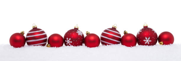 Red christmas big and small balls isolated on snow