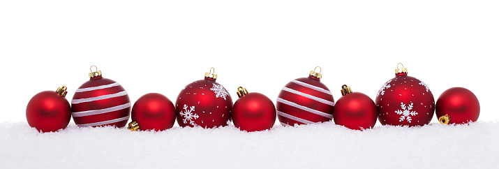Red christmas big and small balls isolated on snow, Christmas decoration
