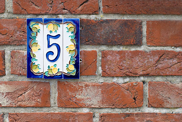 istock Brick wall with house number plate 105927995