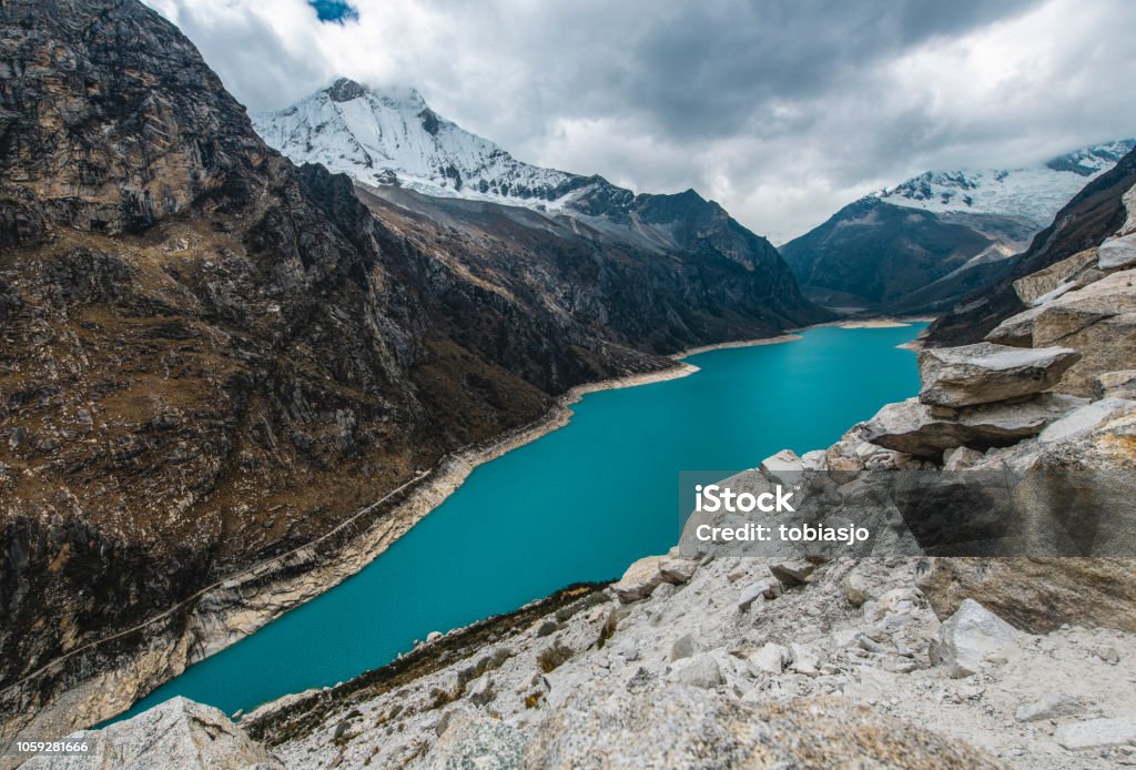 Andes Lake Paron, Peru Lake Paron, a glacier lake located 4200 meter above sea level, is a popular tourist spot in Peru. The glacier lake with its turquoise water in front of the cordillera blanca mountain range is spectacular. Bolivian Andes Stock Photo