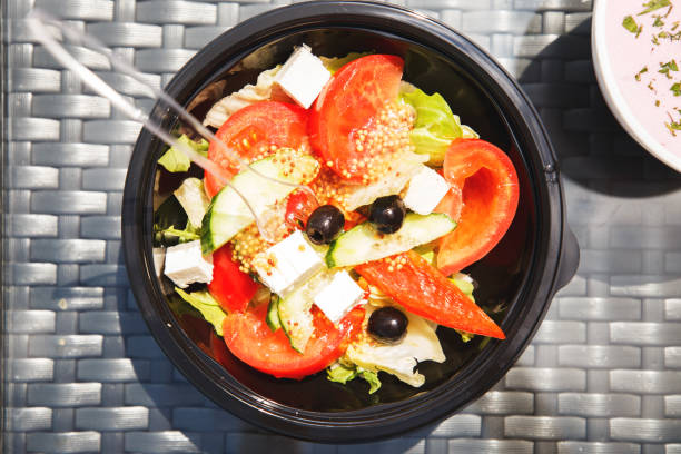 istock Greek salad on a plate on a table in a cafe 1059281760