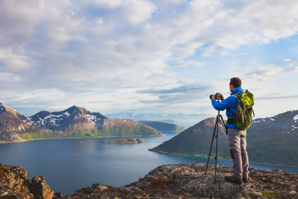 Photographer working with tripod and dslr camera.