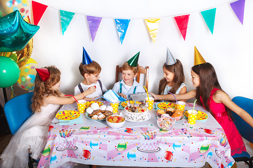 Happy kids with cake and ballons. Children on birthday party