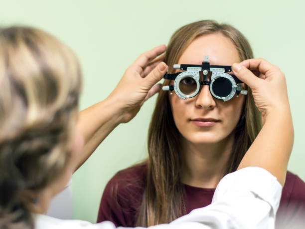 istock Young woman having her eyes checked at ophthalmologist 1059286246