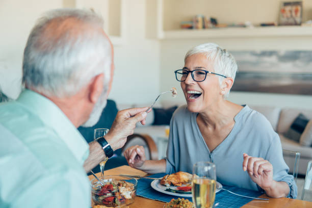 istock Man sharing food with his wife 1059286476