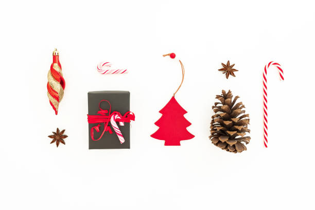 istock Christmas gift, pine cone, toys and candy cane on white background. Flat lay, top view. Creativity New Year concept 1059288398