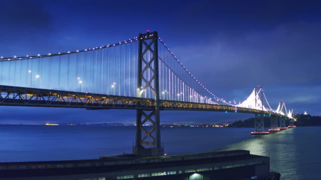 San Francisco-Oakland Bay Bridge Lit Up at Night - Drone Shot