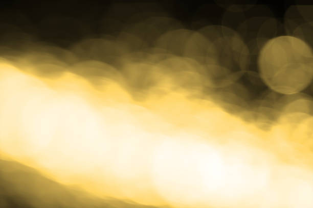 istock Abstract blurred gold bokeh lights background. Defocused glitter light. 1059297594