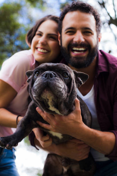 istock Couple in the park with their pet 1059306306