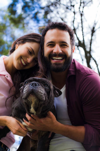 istock Couple in the park with their pet 1059306742