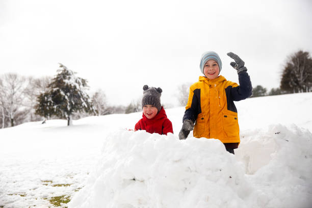 children play in the snow fort