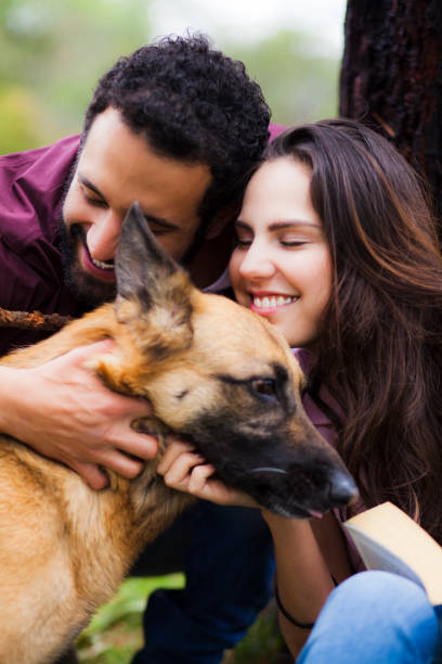istock Couple in the park playing with their pet 1059307328