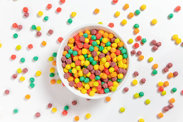 bowl of colorful cereal balls on white background