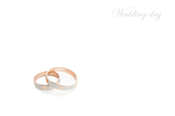 istock Wedding rings on wedding card on a white background 1059311774