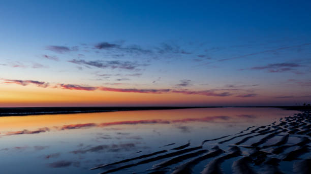 istock Beach sunset with blue and orange sky 1059311868
