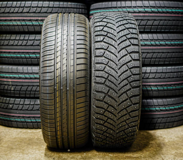 istock beside new winter tire with studs and summer tire 1059312454