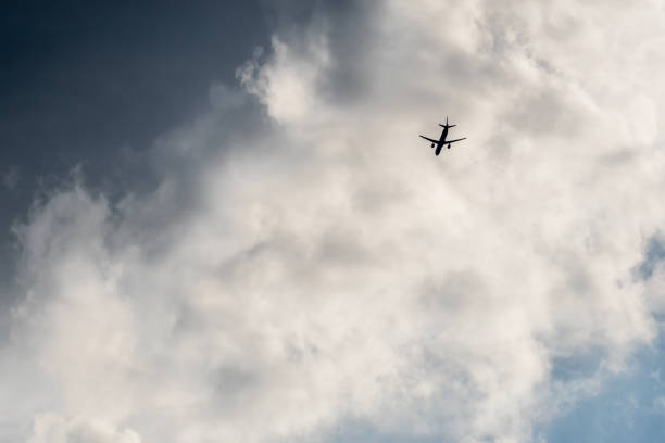 istock The plane flies in the clouds 1059312492