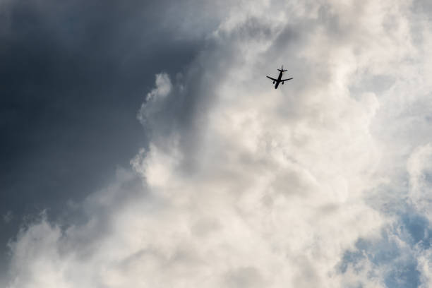 istock The plane flies in the clouds 1059312502
