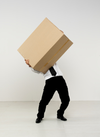 Businessman holding or carrying cardboard box.