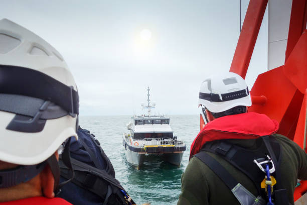 istock Offshore manual workers preparing for for transfer and looking on boat. 1059319326