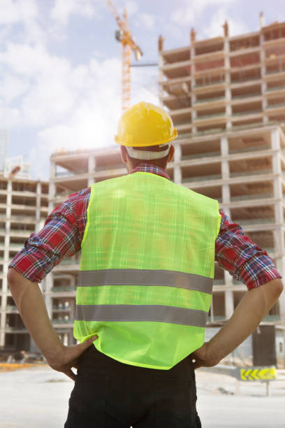 istock Young Engineer portrait with construction site and crane background. 1059320870