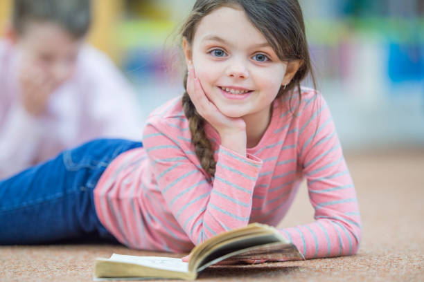 istock Little girl reading 1059321104