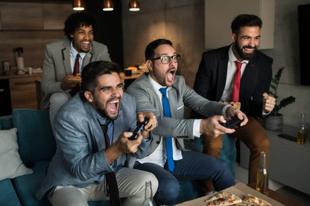A group of young business man playing video games after work