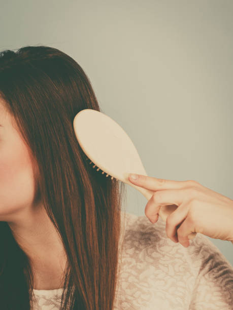 istock Happy woman brushing her hair 1059325408