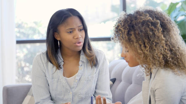 istock Distressed young woman speaks with counselor 1059325862