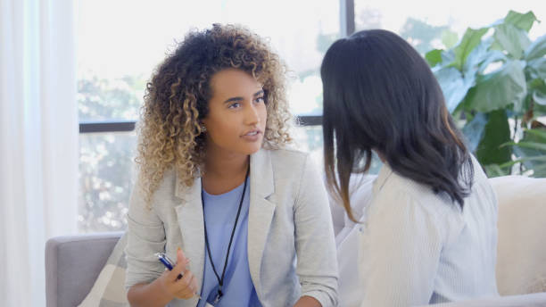 istock Young counselor speaks candidly with patient 1059325882