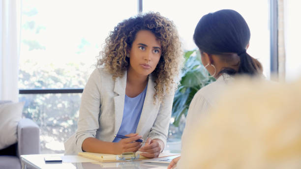 istock Young counselor speaks to patient in office 1059325886