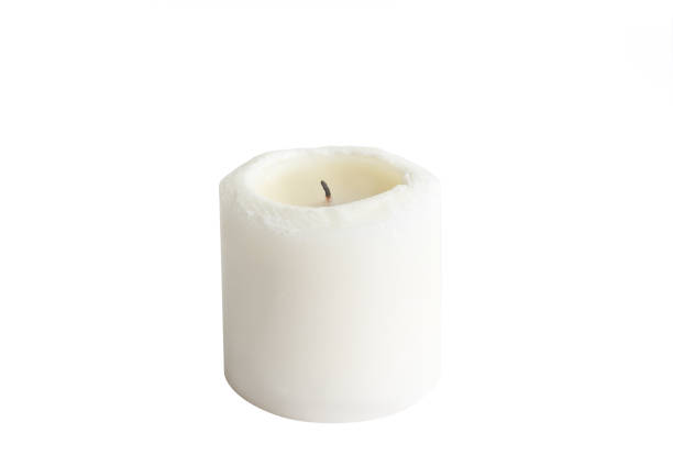 istock White candle on white background isolated. Wax candle 1059325986