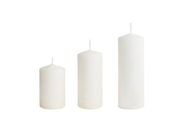 istock White candle on white background isolated. Wax candle 1059326074
