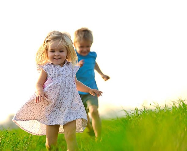 istock Two children running in a green field 105932739
