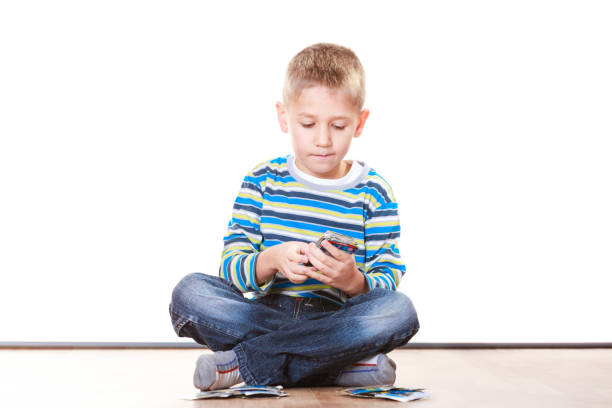 istock Little boys have fun and play cards. 1059327722