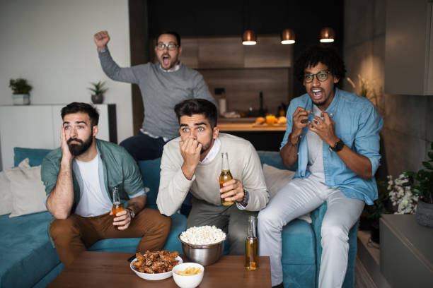 istock Friends watching sport on tv. 1059331144