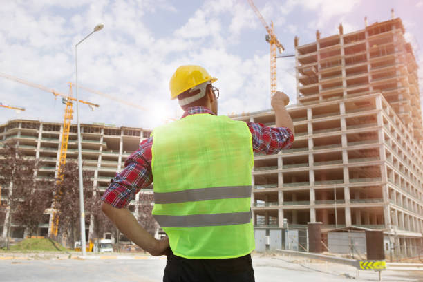 istock Young Engineer portrait with construction site and crane background. 1059332638