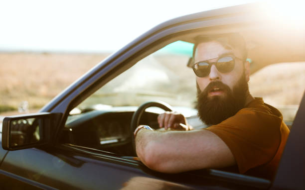 istock Hipster man traveling by car 1059334362