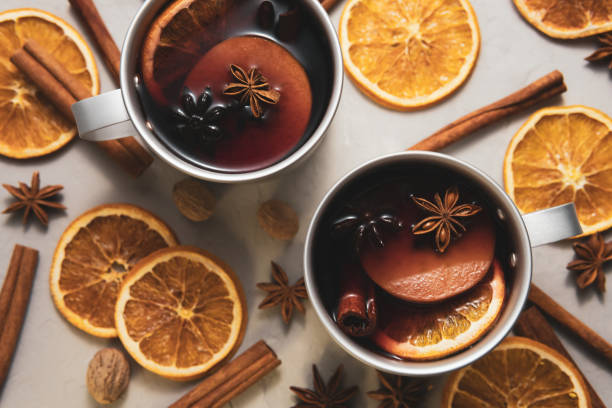 istock Top view of two metal cups with mulled wine among different spices 1059334530