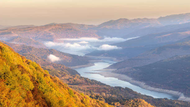 istock Morning mist over meandering lake 1059338904