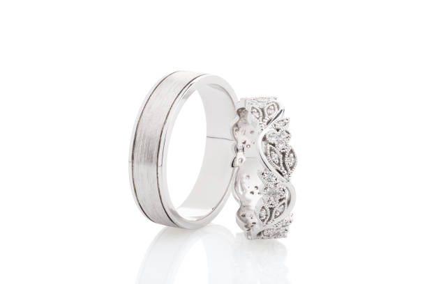 istock Pair of silver wedding rings with diamonds isolated on white background 1059339872